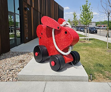 Bunny (Pull Toy) is a sculpture of a large red bunny on wheels with a rope that you can pull.