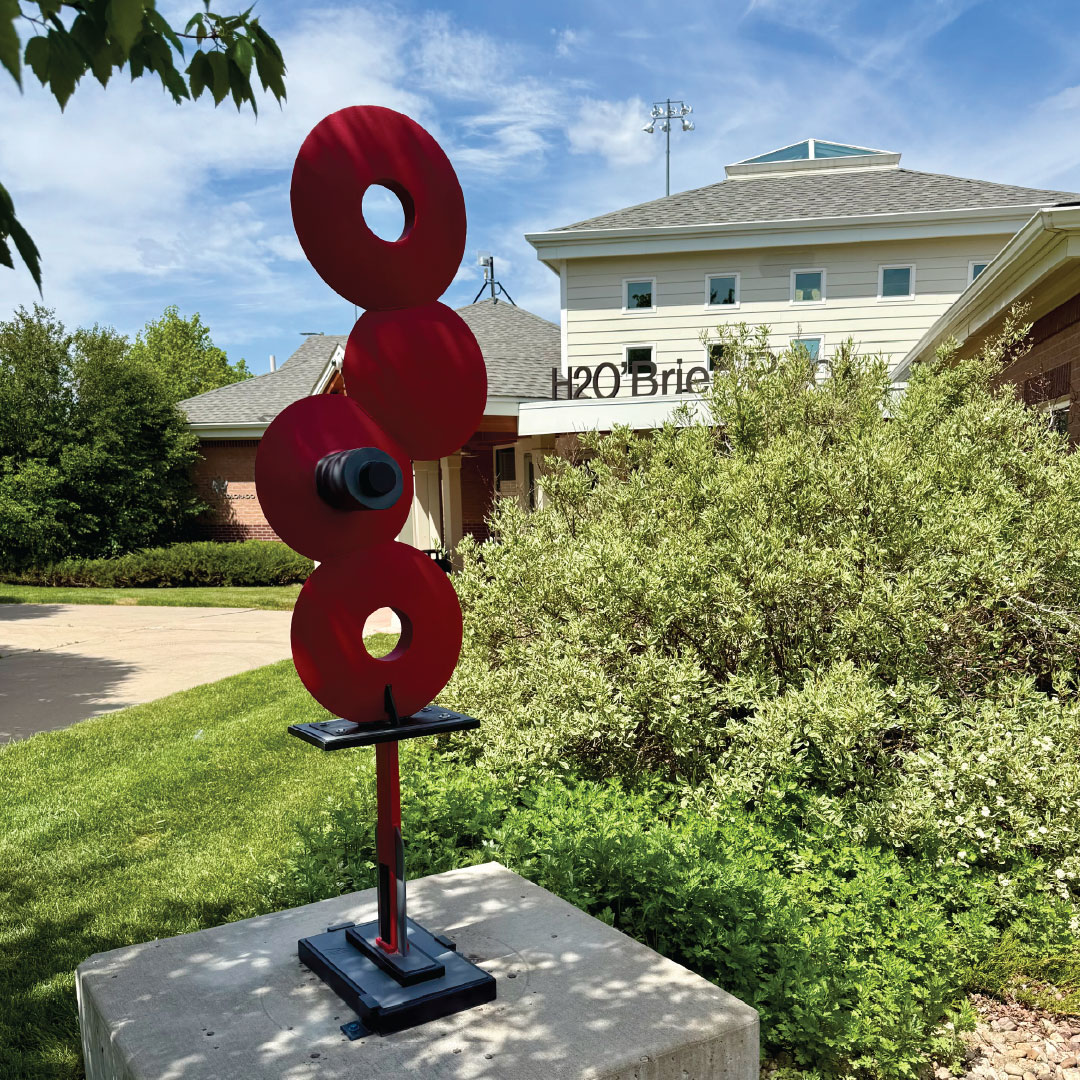 Disco Deco is a sculpture consisting of four units of attached 16-inch farm disks.