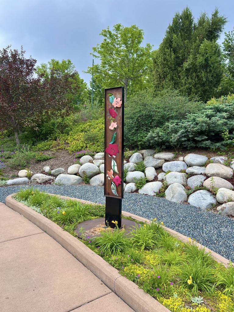 Find Beauty is a tall vertical sculpture that brings flower power to the community.
