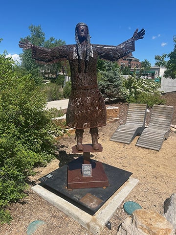 Her Heart Sings is a sculpture of a joyful native woman dancing and singing.