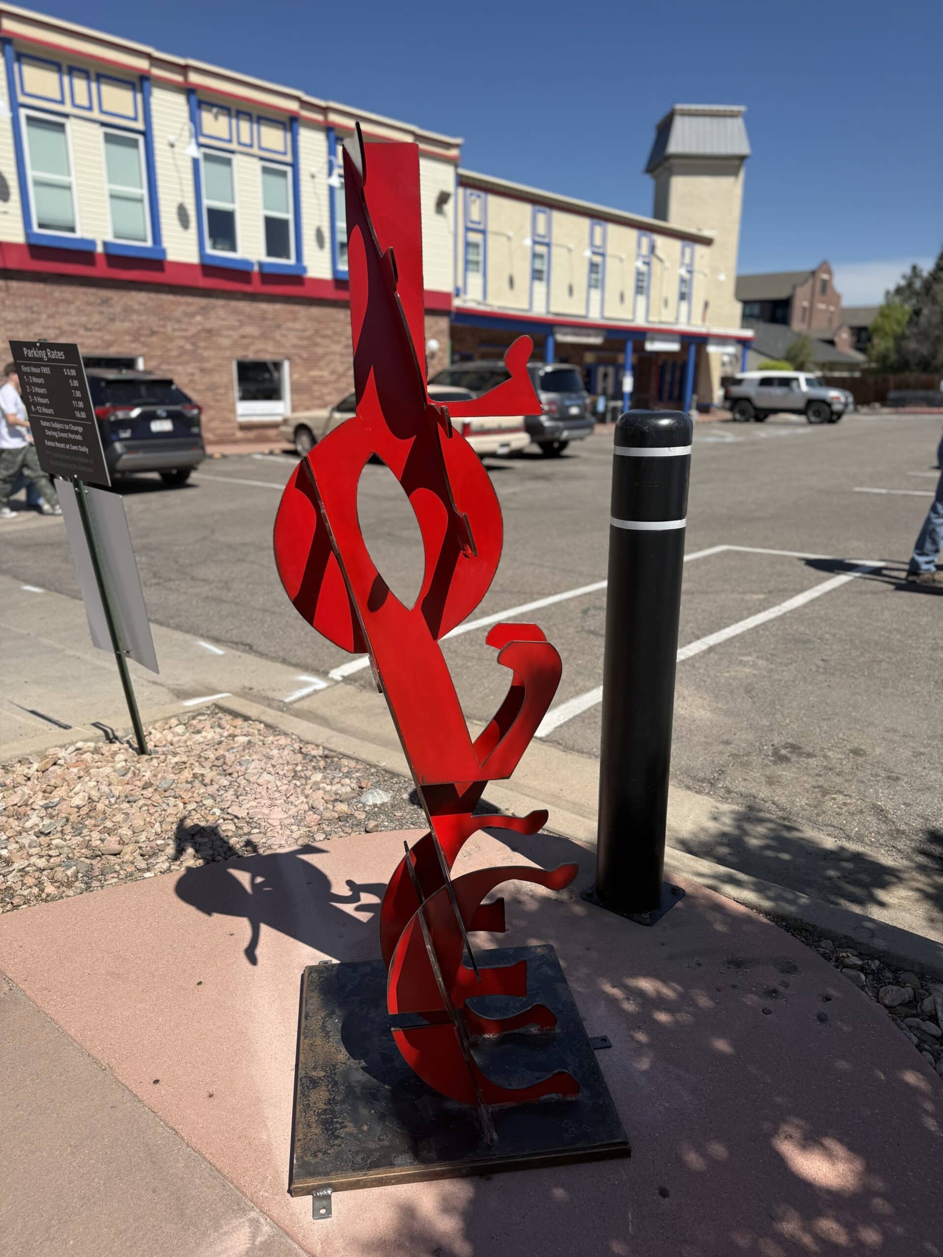 Fear and Love is a red, metal sculpture where you can read the words "FEAR" or "Love" depending on the viewpoint of the observer.