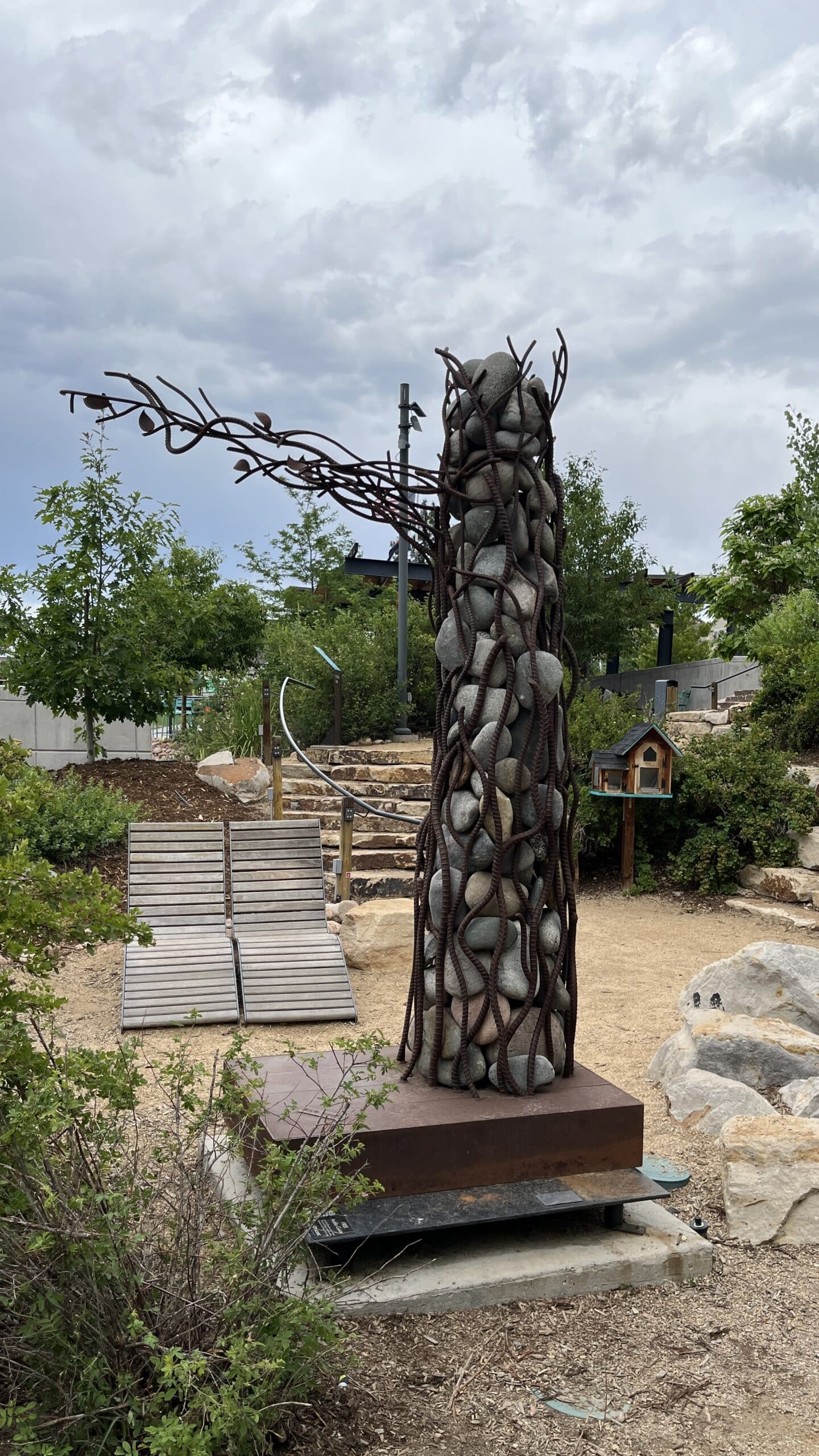 Stumped is a 9-foot tall, 900 lb. metal tree where the exterior is formed from slick rod and the interior is filled with colorful Colorado river rock.