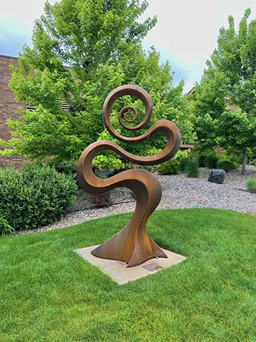 Infinity Unlocked is an abstract, steel sculpture that includes aspects of the plant and animal kingdom.