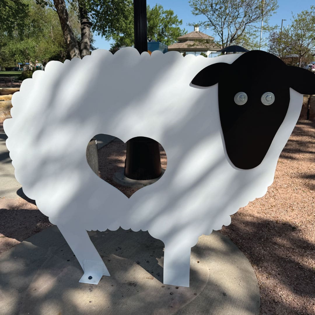 Love Ewe is a sculpture of a white, steel sheep with a cut-out heart in the middle where you can stick your head and post for a photo.