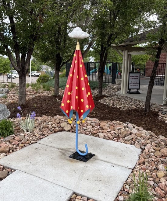 Miss Poppin's Favorite is a sculpture of a large red umbrella with a cloud over it in tribute to the movie.