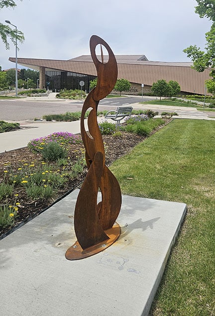 Moontime is a sculpture featuring vertical curving steel shapes that hint of the cycles of the moon.