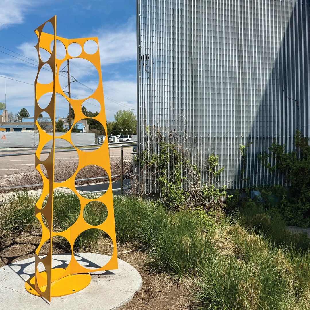 Possibilities is a yellow, steel sculpture that uses negative space to create more space.