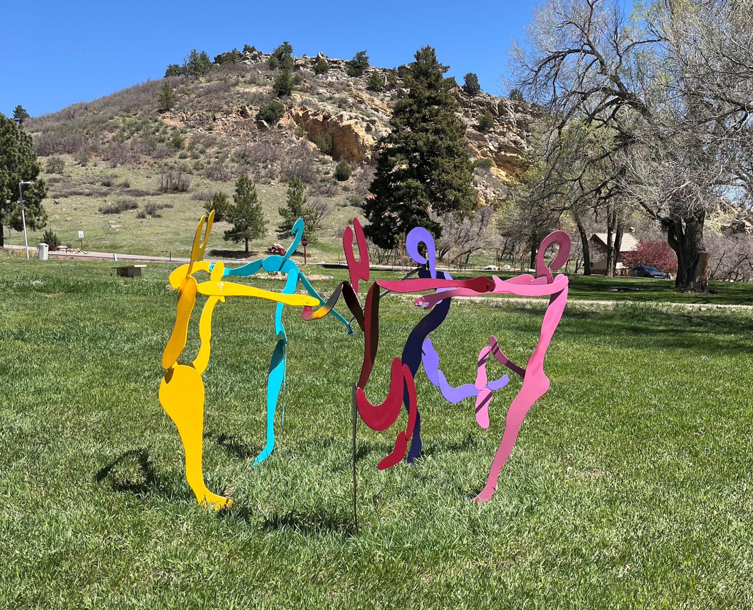 Ring Around the Rosy is a steel sculpture where each person is a different color. It represents a celebration of life and gratitude.