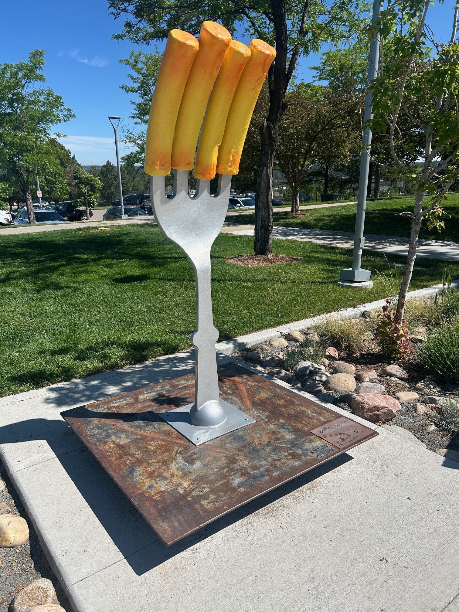 Say Cheese is a sculpture with a fork with mac and cheese noodles.