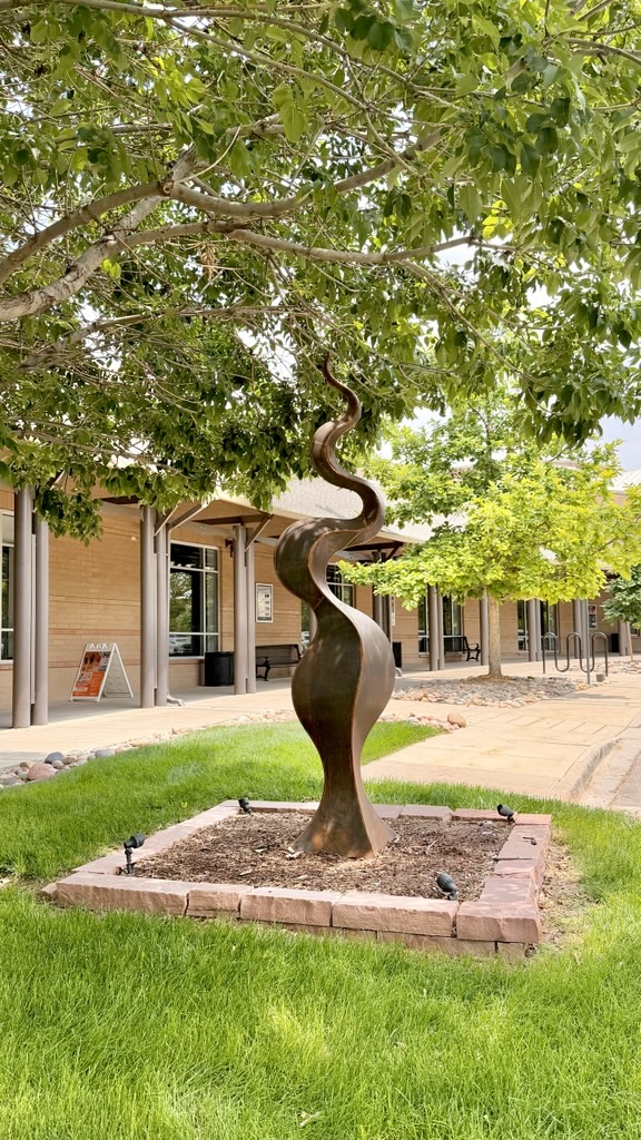 Serpent Obelisk is a large abstract steel sculpture reminiscent of a serpent as well as a new vine that is springing up out of the ground.