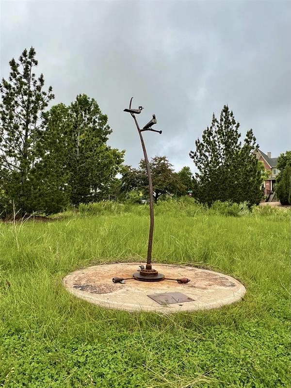 Woodpeckers is a metal sculpture inspired by two wood splitters that reminded the artist of birds.